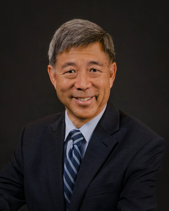 man in black suit and blue strip tie