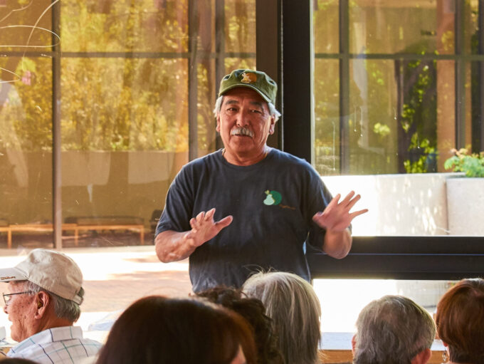 man wearing hat gesturing with hands