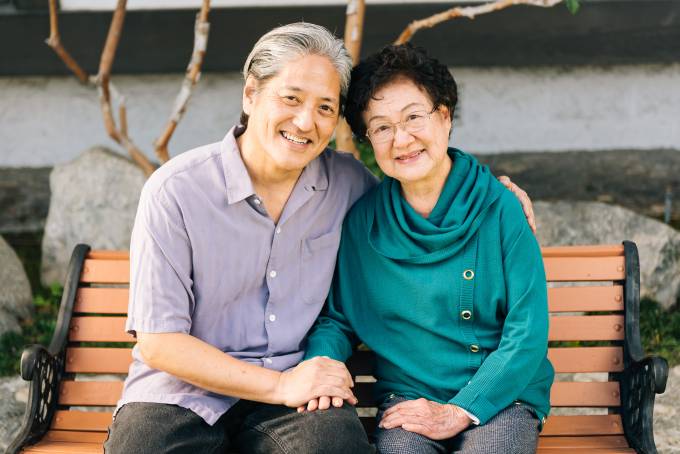 man and older woman on a bench
