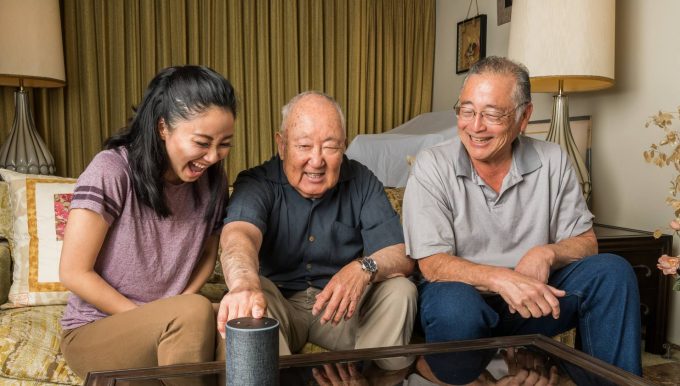 Older adult using smarthome tech with other family members