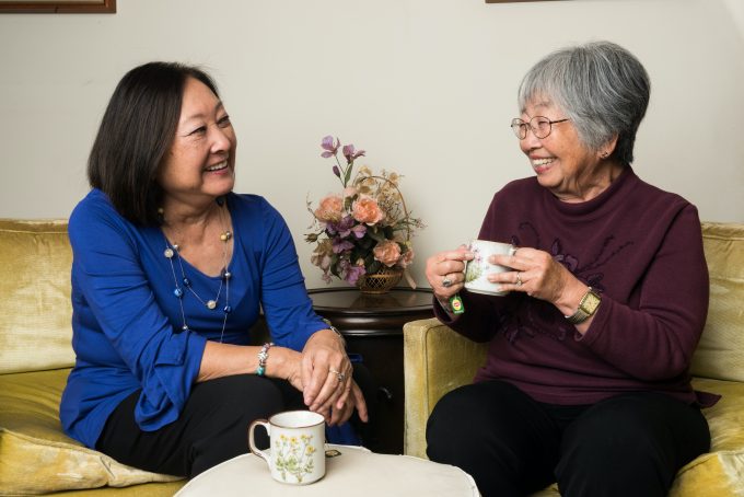 older adult and caregiver having tea