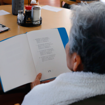 older adult looking into a binder