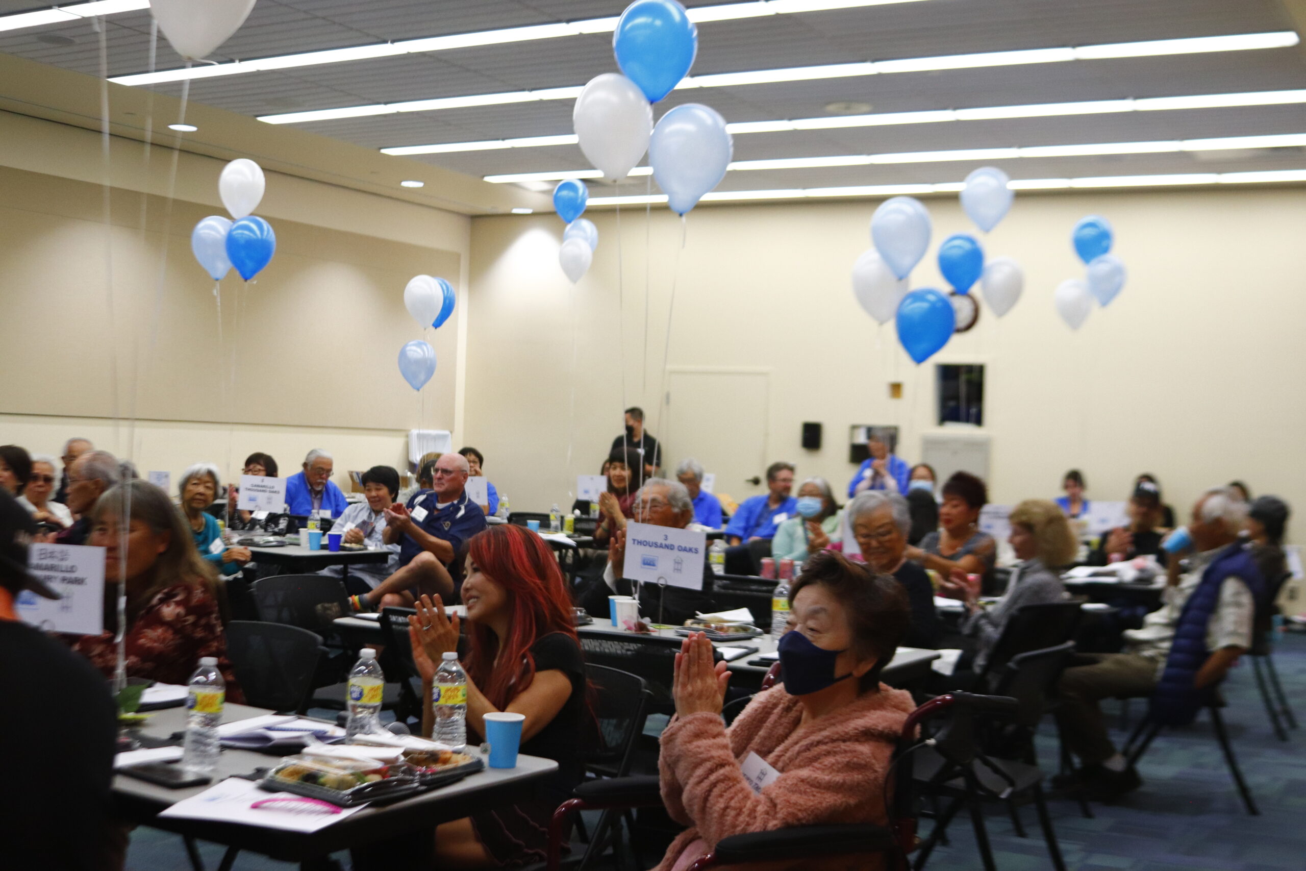 group of people sitting with balloons