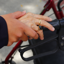 Hand holding hand on walker