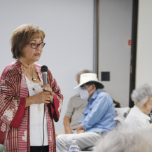 woman speaking into microphone