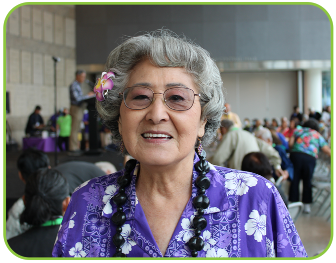 woman smiling wearing an aloha shirt