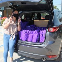 volunteers help load vans for deliveries