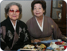 Two adult women wearing Kimonos