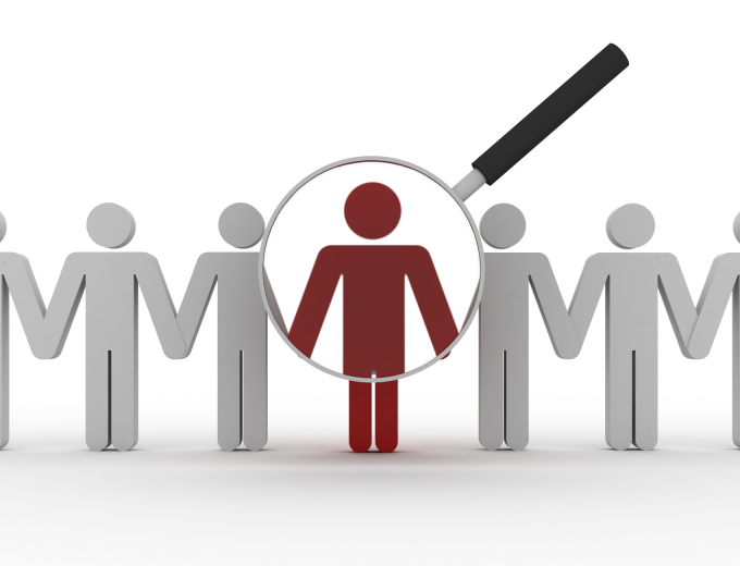 magnifying glass focused on one person in a line of people