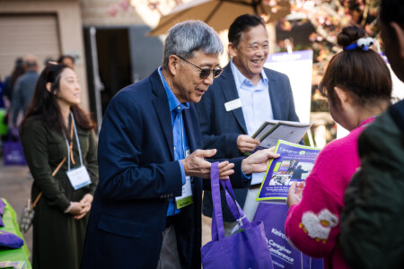 Jack Kurihara handing out gift bag to conference attendee