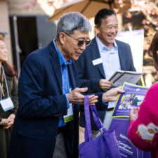 Jack Kurihara handing out gift bag to conference attendee
