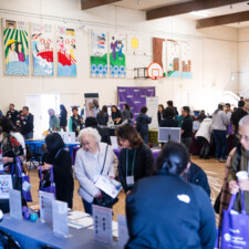 resource fair tables and conference attendees