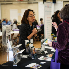resource fair vendor talking to conference attendee