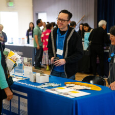 resource fair vendor talking to conference attendee