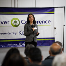 Roxy Kirakosyan speaking on stage with microphone