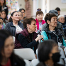 conference attendee speaking into microphone in crowd