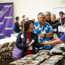 conference attendee smiling while receiving bento boxes
