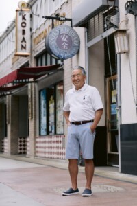 man posing with his hands in his pockets