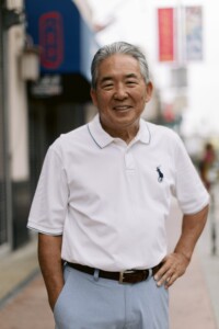 smiling man with his hand on his hip
