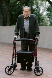 older man posing with a walker