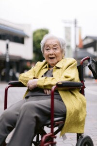 older woman in a wheelchair with vibrant clothes