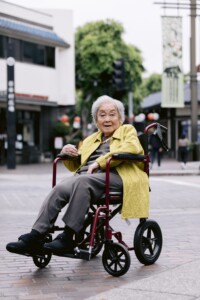 older woman in a wheelchair with vibrant clothes