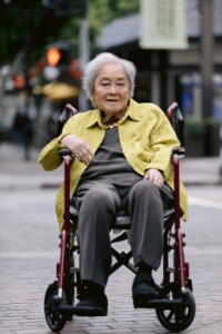 older woman in a wheelchair with vibrant clothes