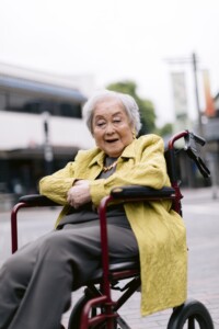 older woman in a wheelchair with vibrant clothes