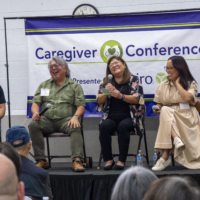 group of panelists laughing on stage