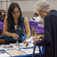 a woman in blue talking with a woman in a blue longsleeve