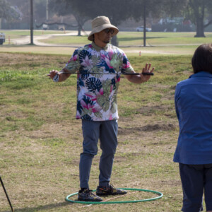 a man in a Hawaiian shirt instructing golf