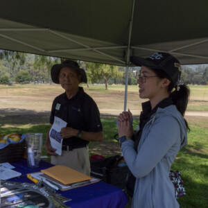 a woman in blue talking to a group of people