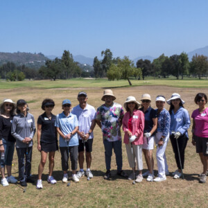 a group of people posing for a photo on the golf course
