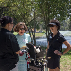 women in black talking to a woman in blue