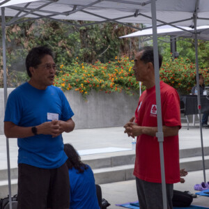 a man in blue talking with a man in red