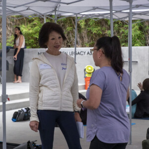 a woman in white tlaking to a woman in purple