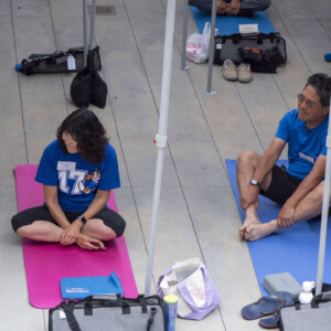 a man and woman in blue sitting and listening