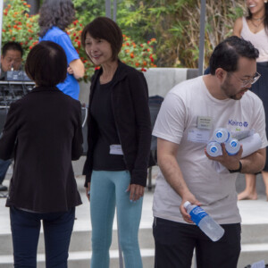 a man in biege handing out Pocari Sweat