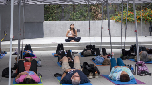 a woman sitting criss cross while other people are laying down