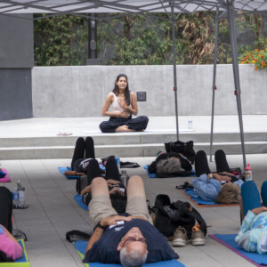 a woman sitting criss cross while other people are laying down