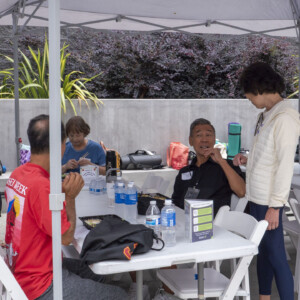 a woman in white talking with a man in black