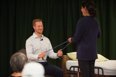 two people demonstrating resistance band exercise