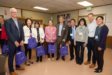 group of nine people smiling