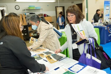 Attendee talking to vendor at resource fair