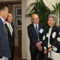 group of four people talking
