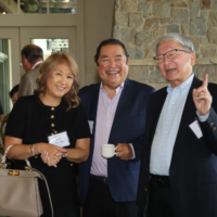 Three event attendees happily posing for a picture