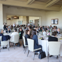 wide shot of people sitting at tables