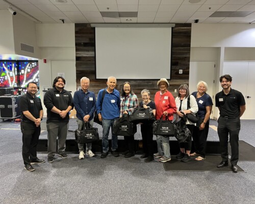 group photo of people with bags
