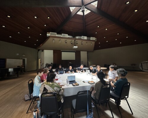 group of people sitting at a large table