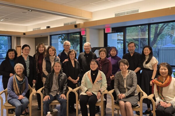 group of 16 people smiling